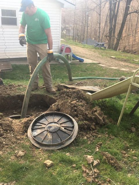 Worker Cleaning the Septic Tank — Mount Nebo, WV — Triple T Septic Service LLC Worker Cleaning the Septic Tank — Mount Nebo, WV — Triple T Septic Service LLC