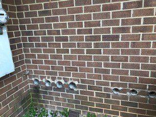 open dryer vents on exterior of brick building