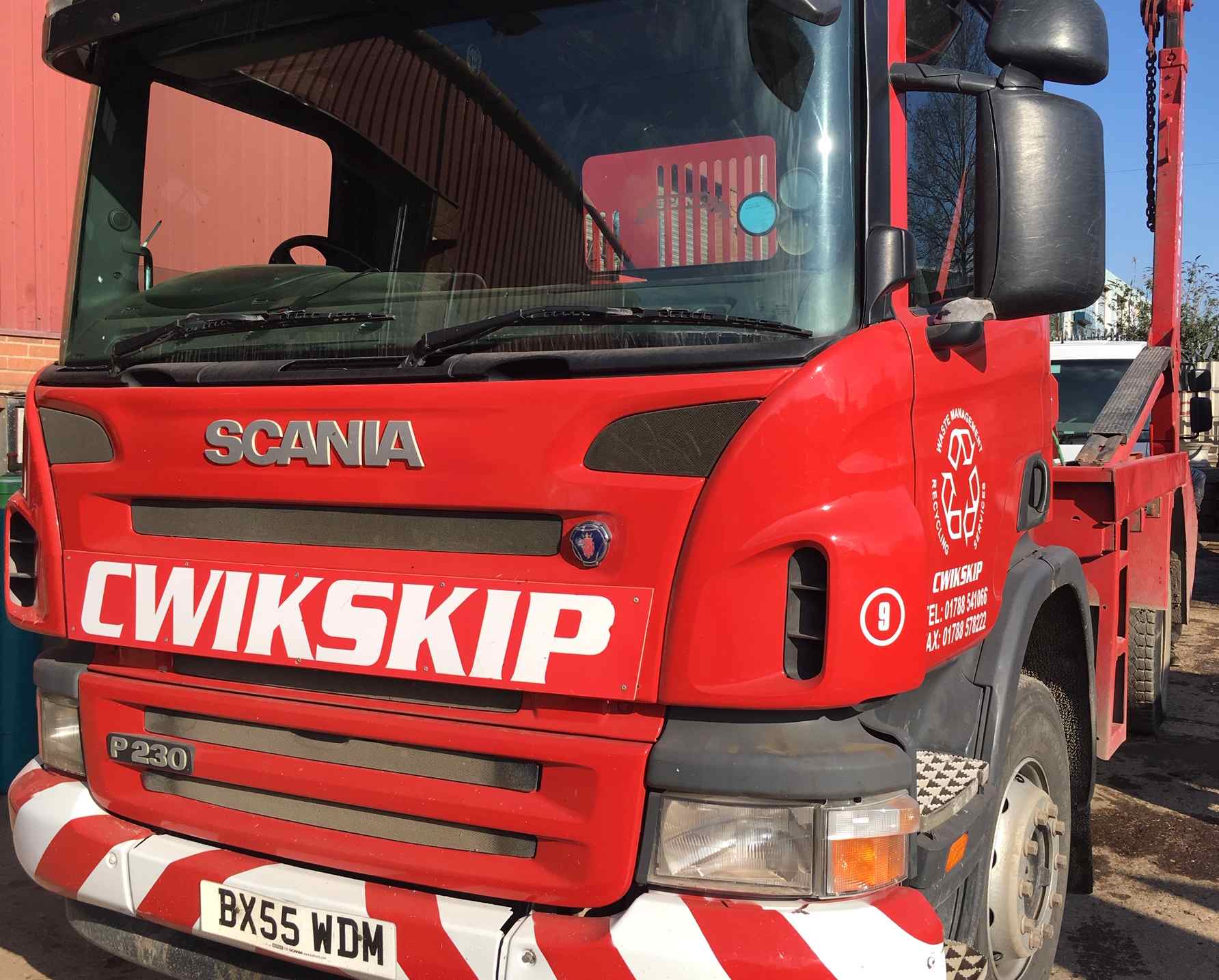 Waste management services in Coventry call 01788 541 066 lorries carrying skips on a road
