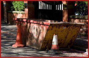 street with yellow skip traffic cones around it