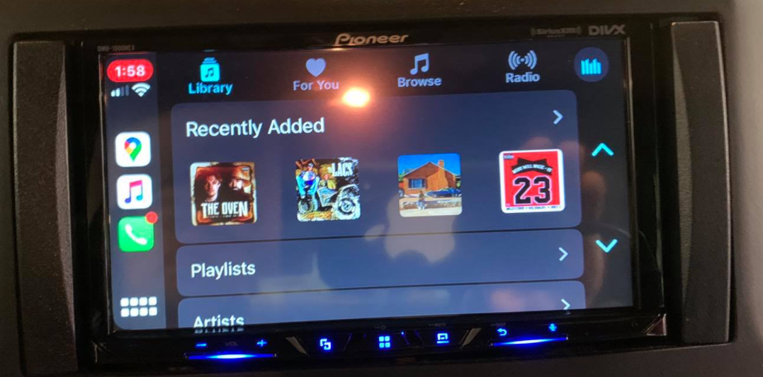 Car dashboard touchscreen showing a Pioneer media interface with “Recently Added” albums and app icons.