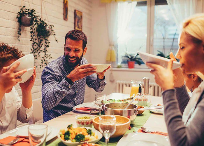 family dinner with registered hearing aid practitioner