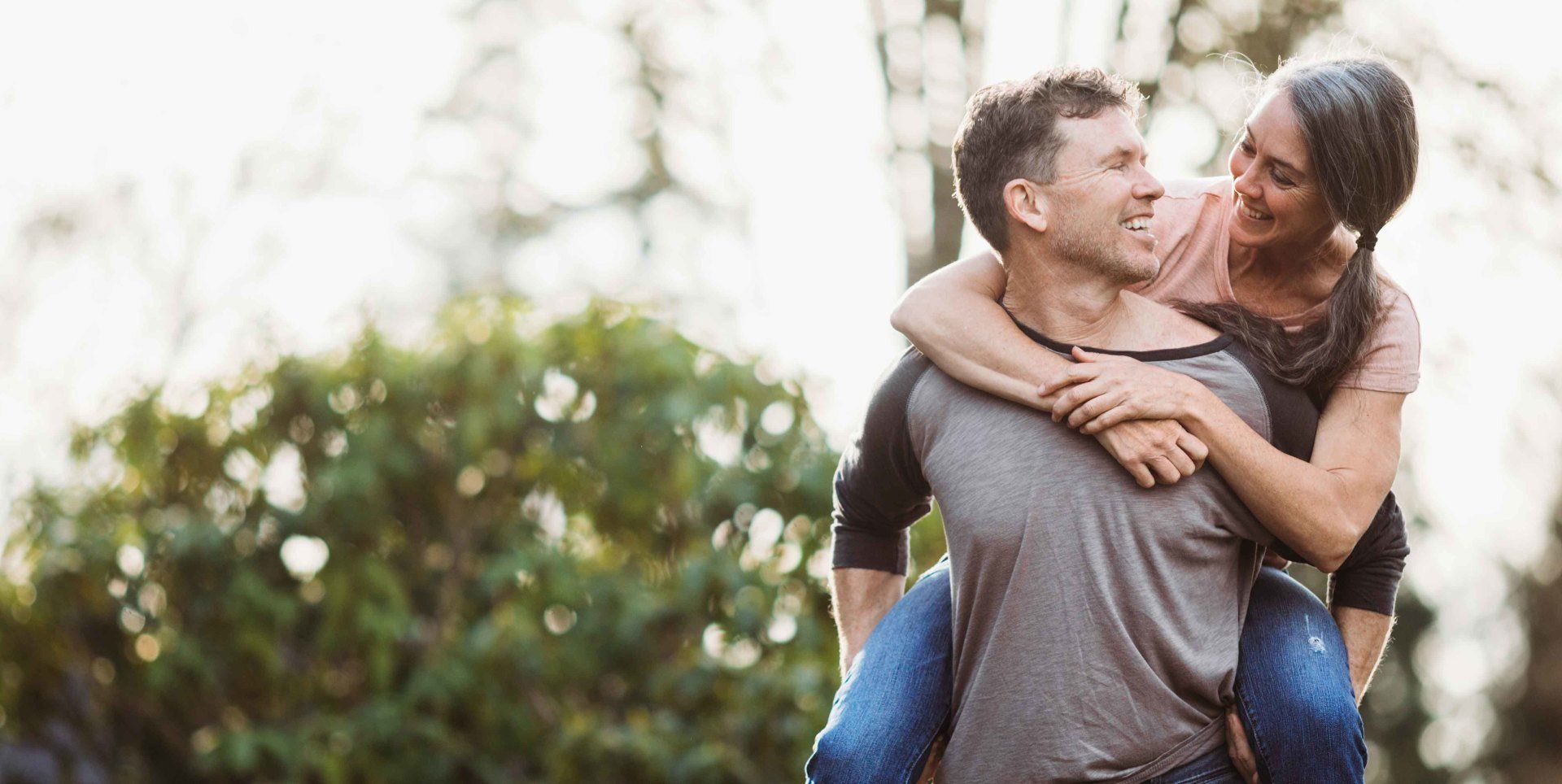 Man carrying woman with hearing loss