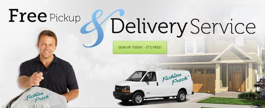 Man holding dry cleaning bag, smiling. Van in front of a house. 