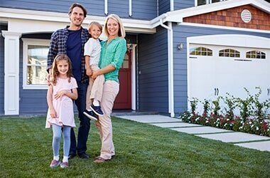 Portrait Of Family Standing Outside House — Basement Repairs in Dr. Buckner, MO