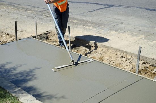 Screeding New Concrete Path