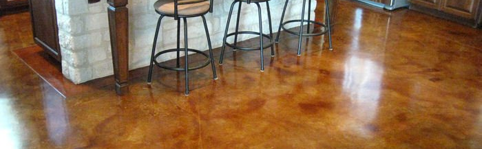 Polished wooden floor in a bar or kitchen area with stools and chairs in the background