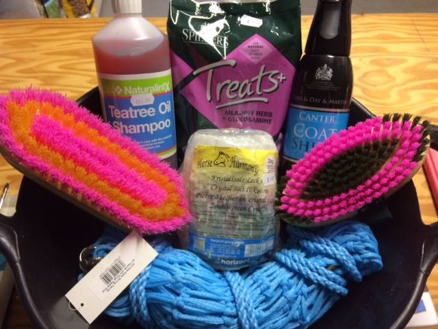 a bag of treats sits next to a bottle of tea tree oil shampoo