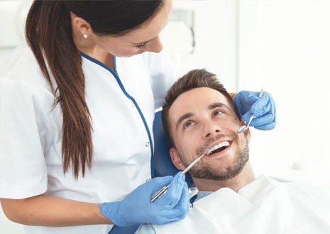 Dentist Doing Dental Checkup — Alliance, OH — Kristine Sigworth, DDS Dentist Doing Dental Checkup — Alliance, OH — Kristine Sigworth, DDS