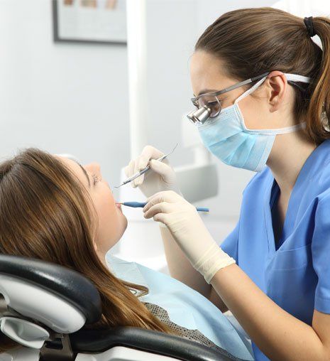 Dentist Examining a Patient Teeth — Alliance, OH — Kristine Sigworth, DDS Dentist Examining a Patient Teeth — Alliance, OH — Kristine Sigworth, DDS