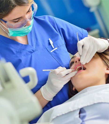 Dentist Checking Girl's Teeth — Alliance, OH — Kristine Sigworth, DDS Dentist Checking Girl's Teeth — Alliance, OH — Kristine Sigworth, DDS