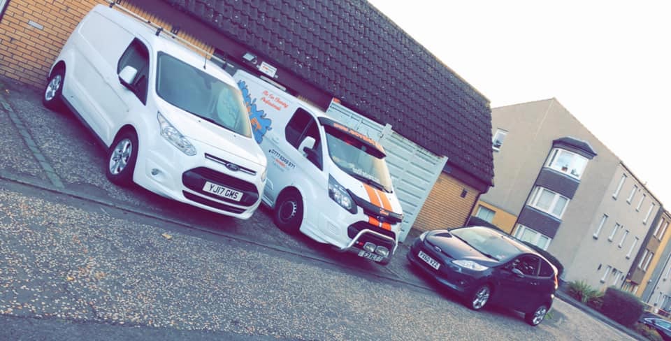 Two commercial white vans cleaned by EC valet