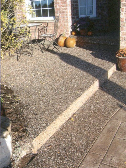 A patio with pumpkins and a table and chairs