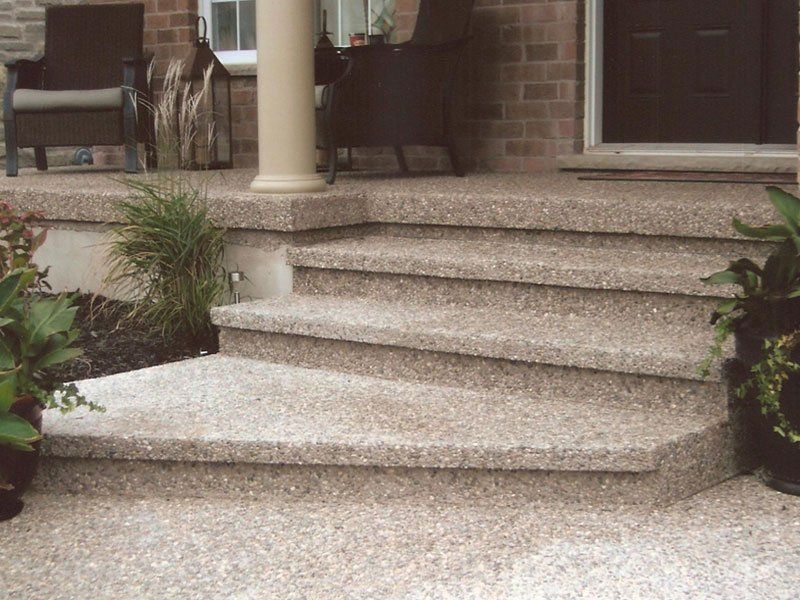 A set of stairs leading up to a porch with chairs