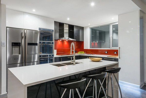 modern kitchen with red backsplash