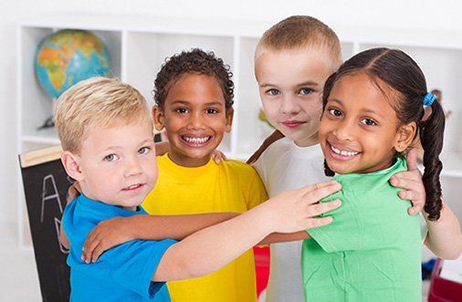 Happy preschool kids hugging - Kindergarten Lowell, MA