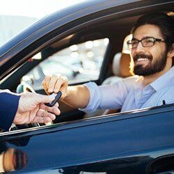 Man with Glass Handing the Key — Collision Repair Parma OH in Parma, OH