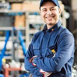 Man Wearing a Blue Uniform with Cap — Collision Repair Parma OH in Parma, OH