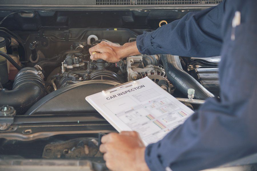 Mechanic inspecting a car engine with a clipboard, checking fluids.
