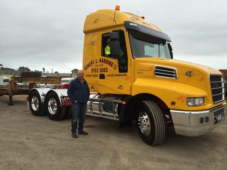 man standing in front of R L Harding Truck