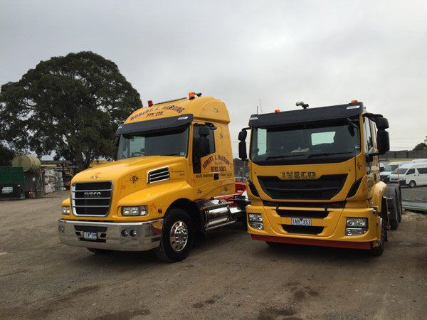 two yellow R L Harding Trucks