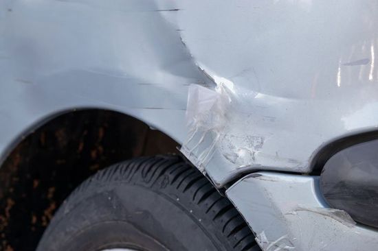 Damaged bumper on a grey car — Pittsfield, MA — Mom's Auto Sales and Associated Autobody Rebuilders Damaged bumper on a grey car — Pittsfield, MA — Mom's Auto Sales and Associated Autobody Rebuilders