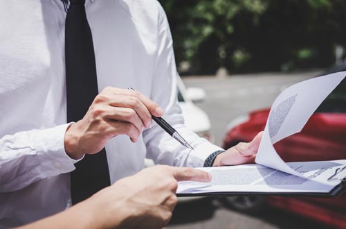 Business Car Insurance — Man Holding Car Insurance Paper in Gallup, NM Business Car Insurance — Man Holding Car Insurance Paper in Gallup, NM