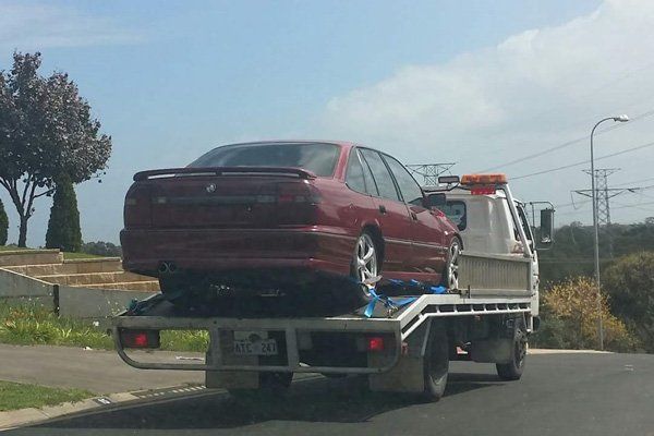 Around the Clock Towing truck towing red car around the clock towing truck towing red car