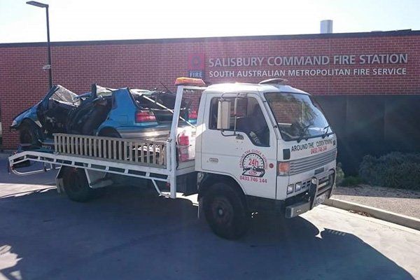 Around the Clock Towing truck towing crumpled car around the clock towing truck towing crumpled car