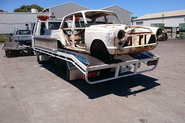 Around the Clock Towing truck towing old car around the clock towing truck towing old car