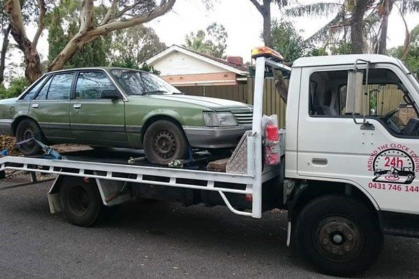 Tow truck towing green car tow truck towing green car