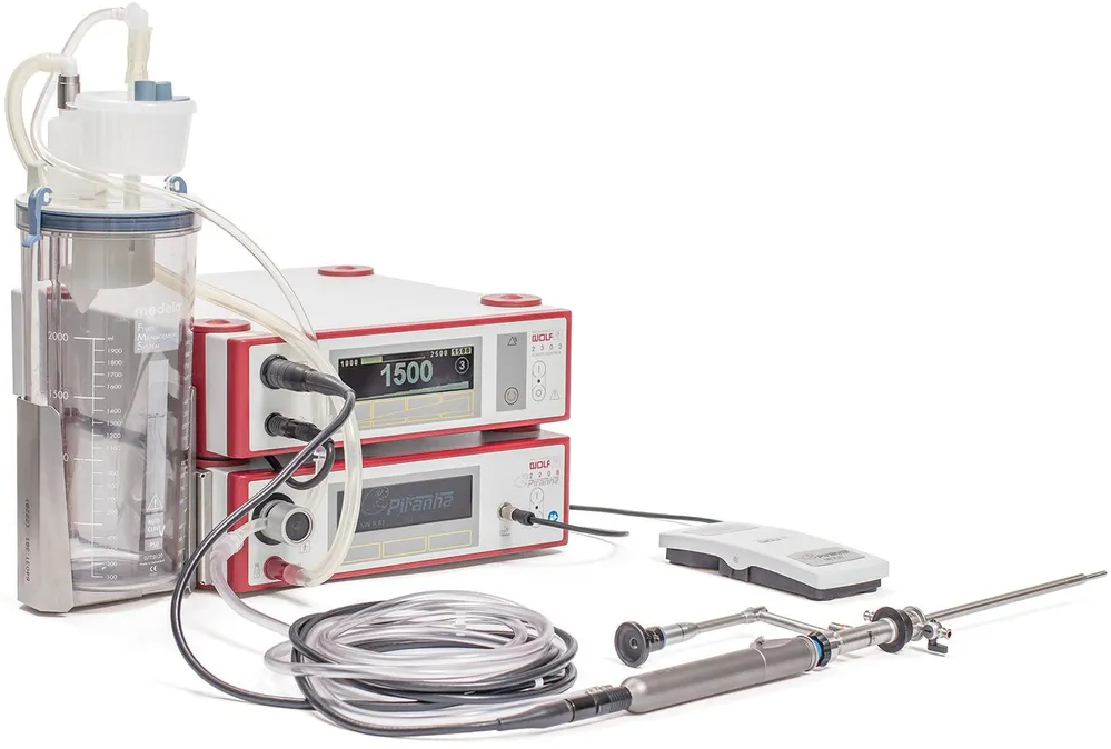 A medical device with a hose attached to it is sitting on a table.