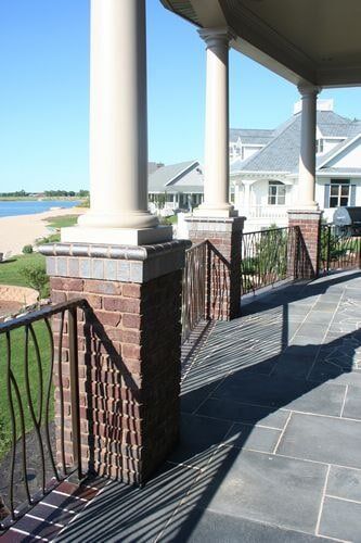 Brick posts on stone patio - Custom patios in Columbus, NE