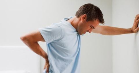 Man Holding His Back — Hawley, PA — Pocono Chiropractic Clinic Man Holding His Back — Hawley, PA — Pocono Chiropractic Clinic