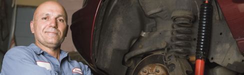 Repairman next to a car