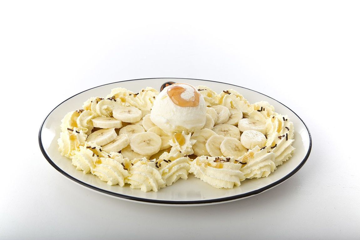 Plate of pasta with sliced mushrooms and a dollop of ricotta or cream on top