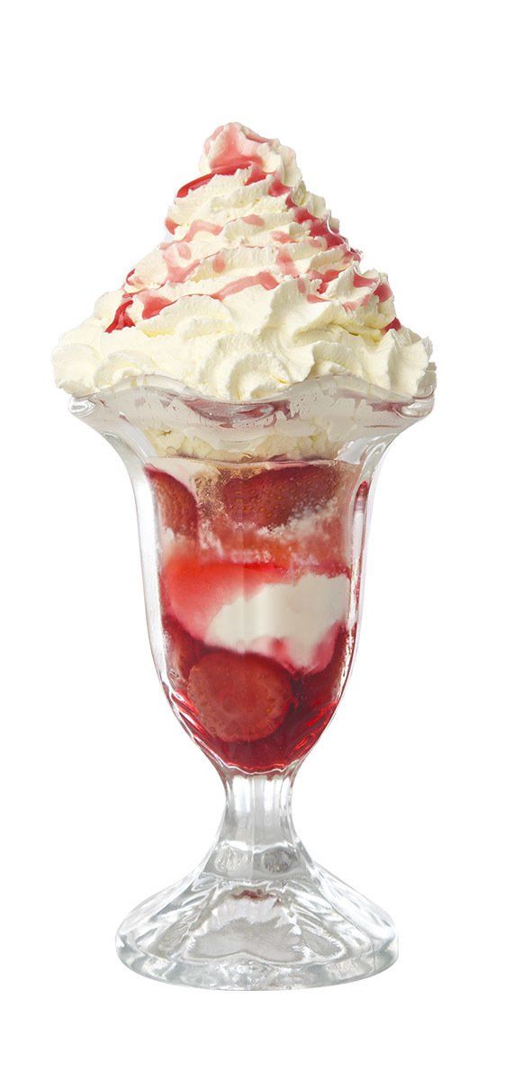 Tall strawberry sundae with whipped cream in a glass dish
