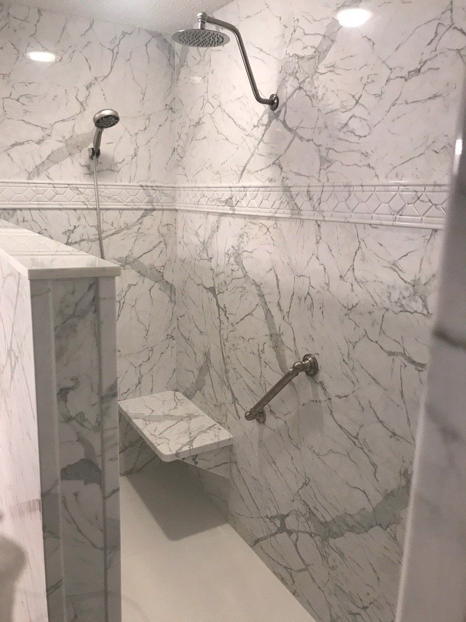 Calcutta Marble Wall Surround with Santa Fe Listello Accent Trim and Seat