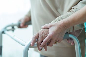 Close-up of woman using walker