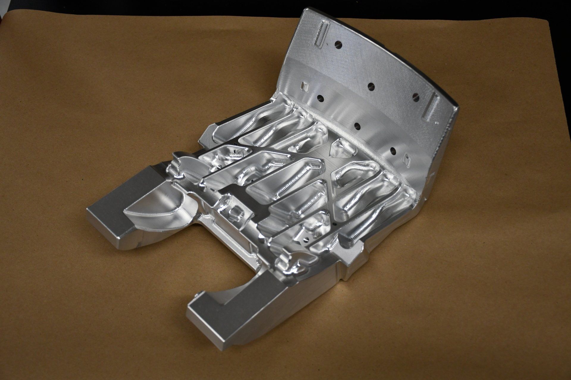 A piece of metal is sitting on a piece of brown paper.