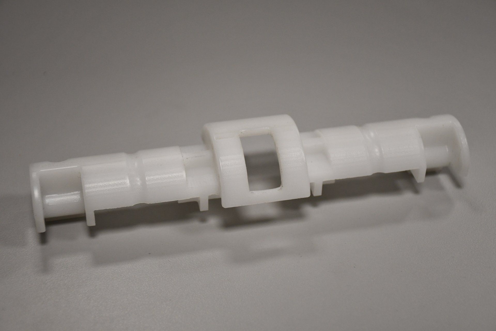 A white plastic object is sitting on a table.