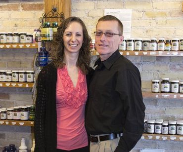 a man and a woman are posing for a picture in a store