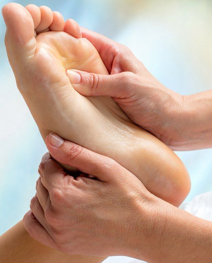a person is getting a foot massage from another person.