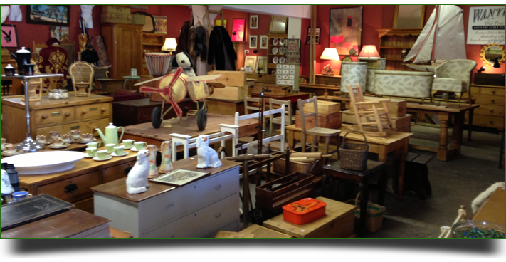 A collection of wooden antiques in red walled room