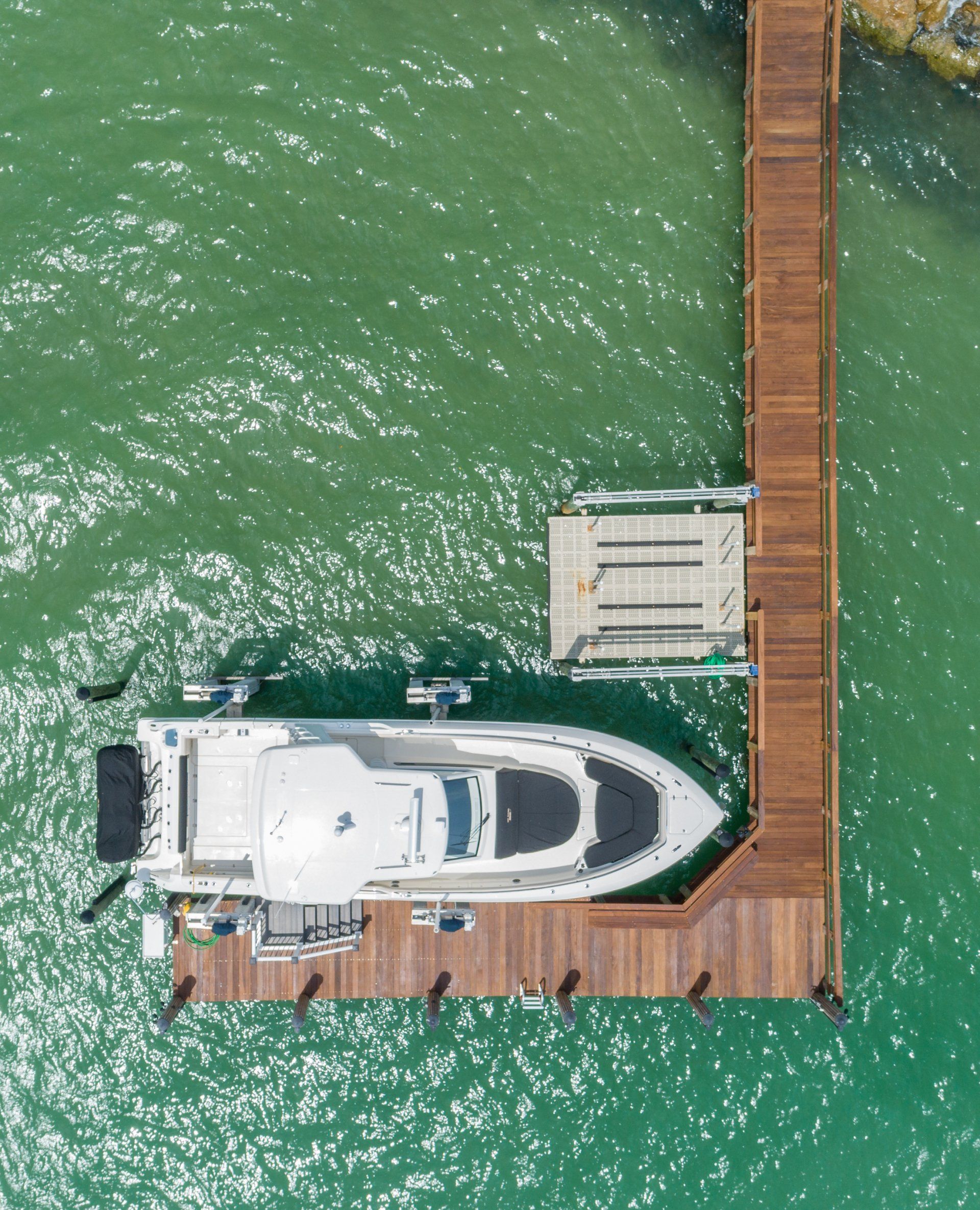 Parked White Yacht — Marco Island, FL — Collier Seawall & Dock
