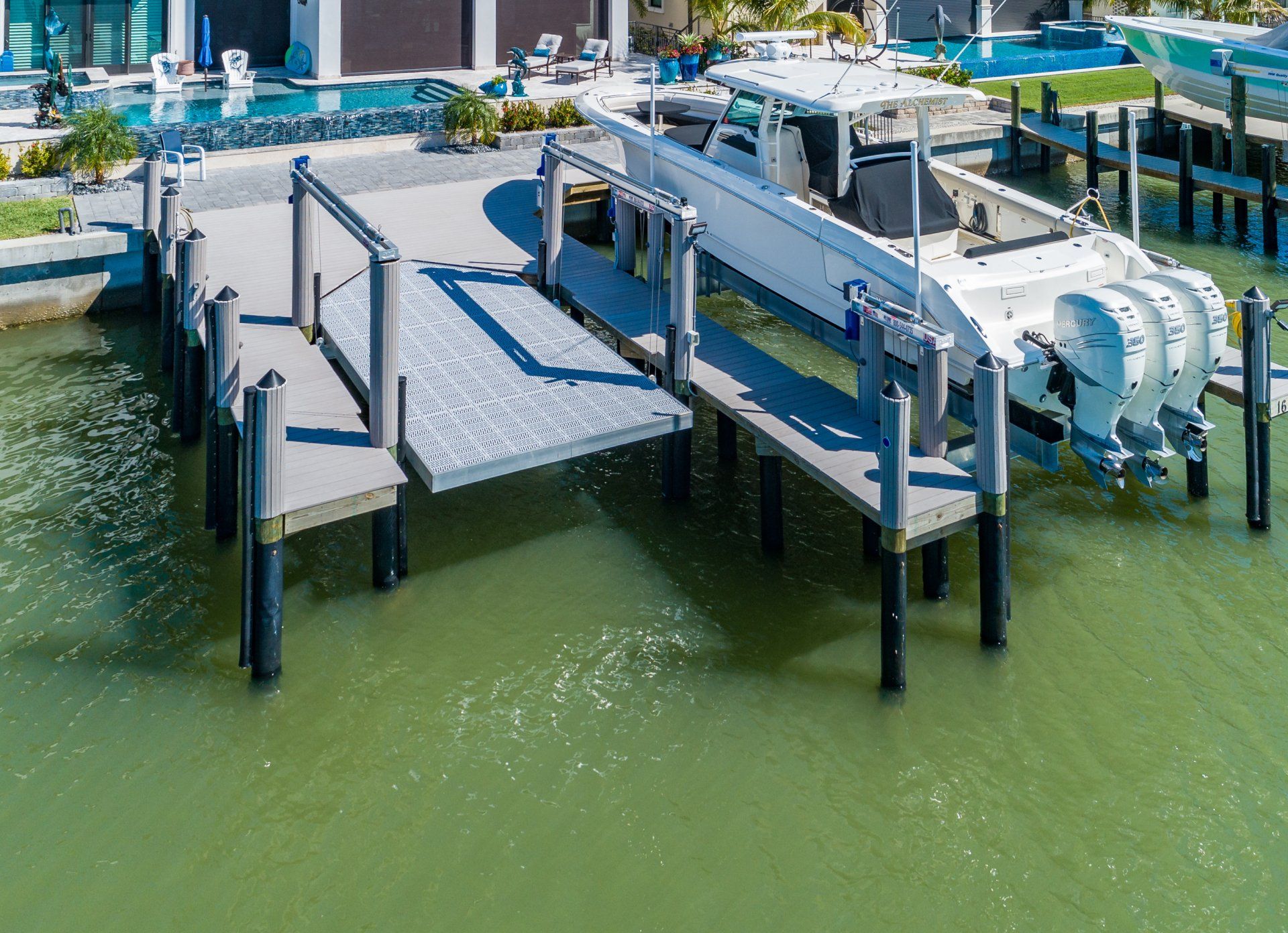 Yacht Beside a Boat Lift — Marco Island, FL — Collier Seawall & Dock