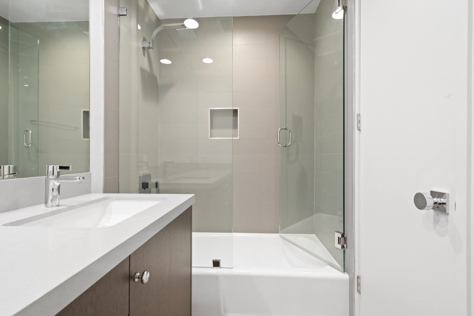 Interior view of bathroom with shower tub and glass door