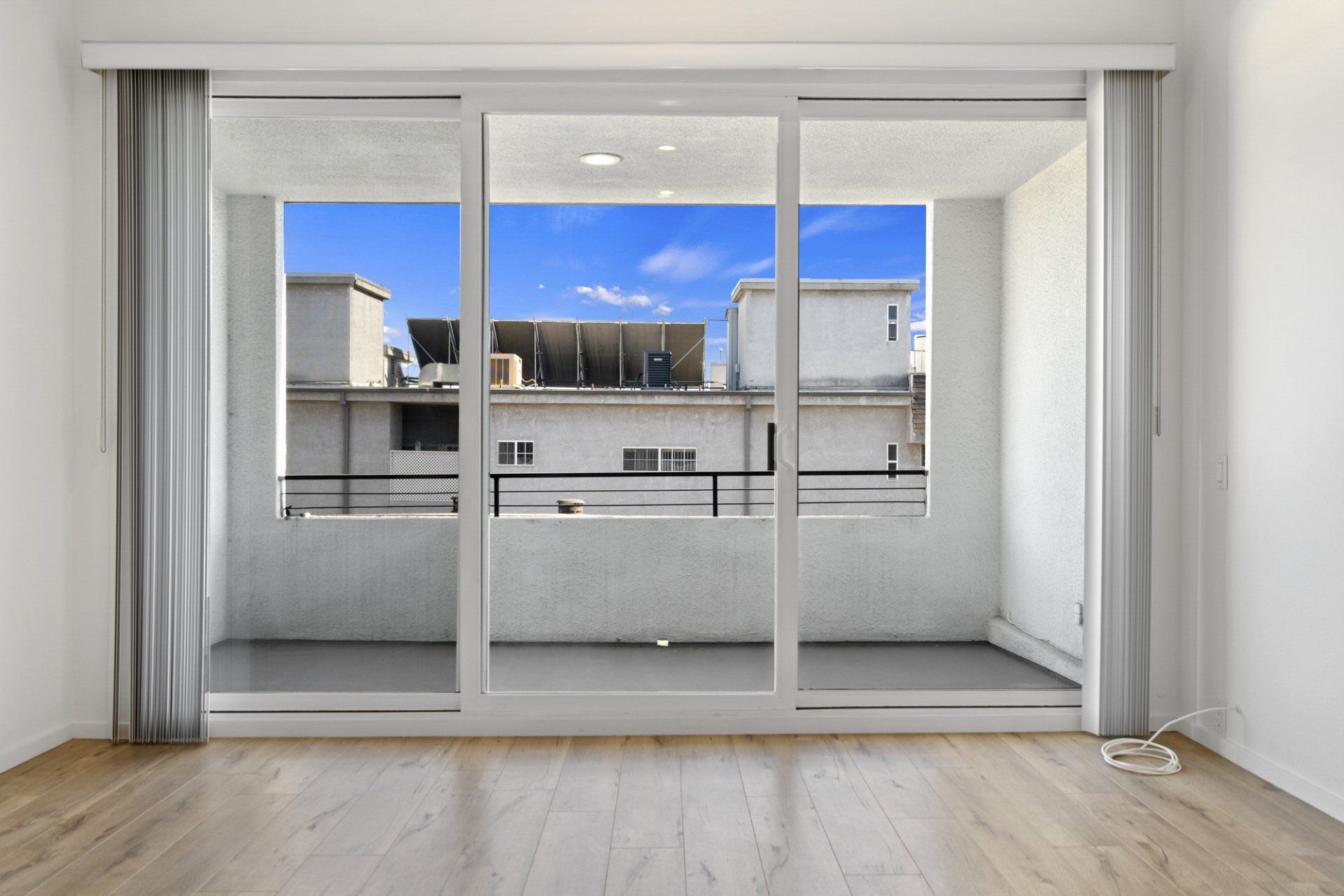 Interior view looking out sliding glass doors to balcony