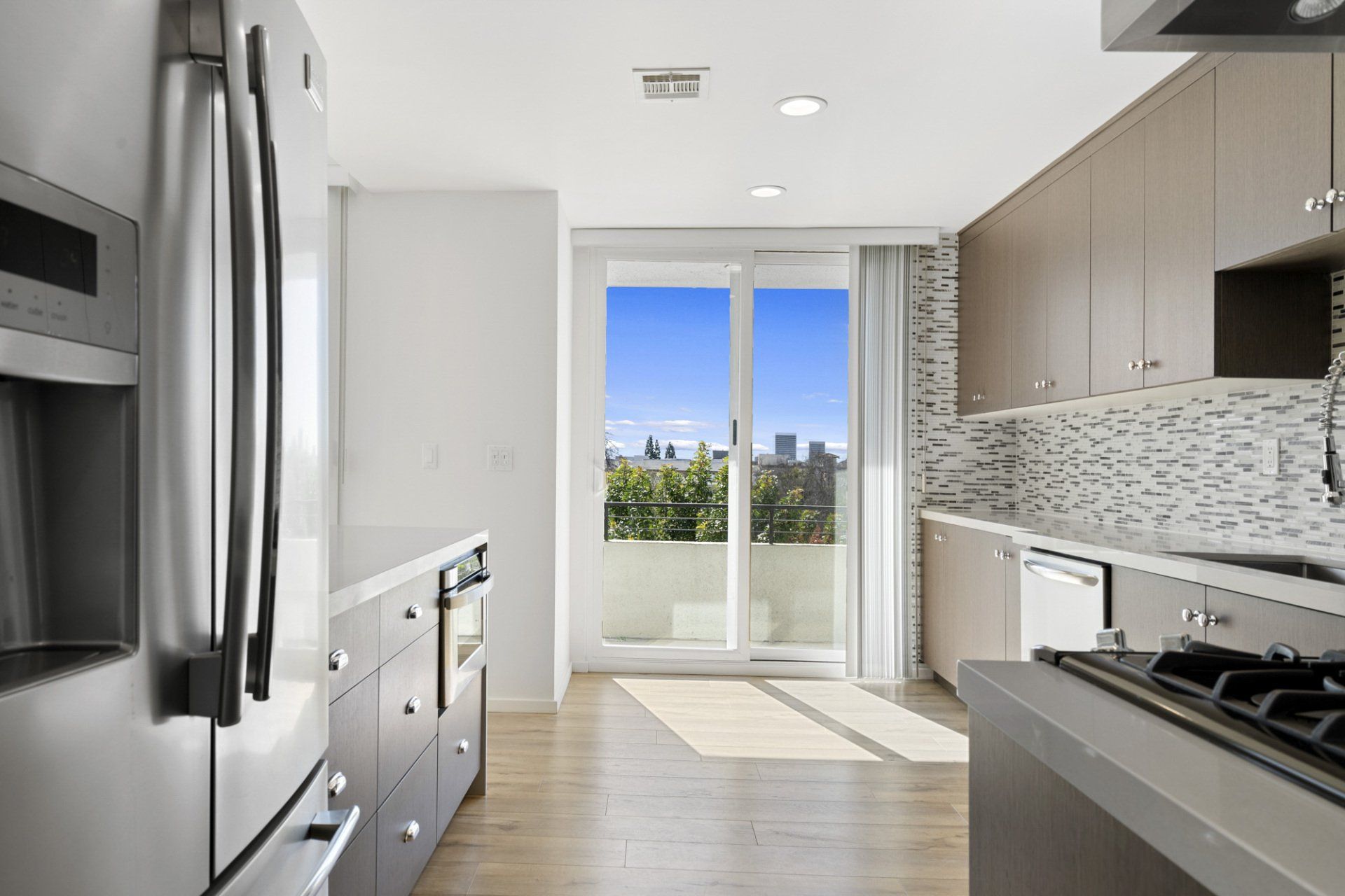 Interior of kitchen with window overlooking forested city