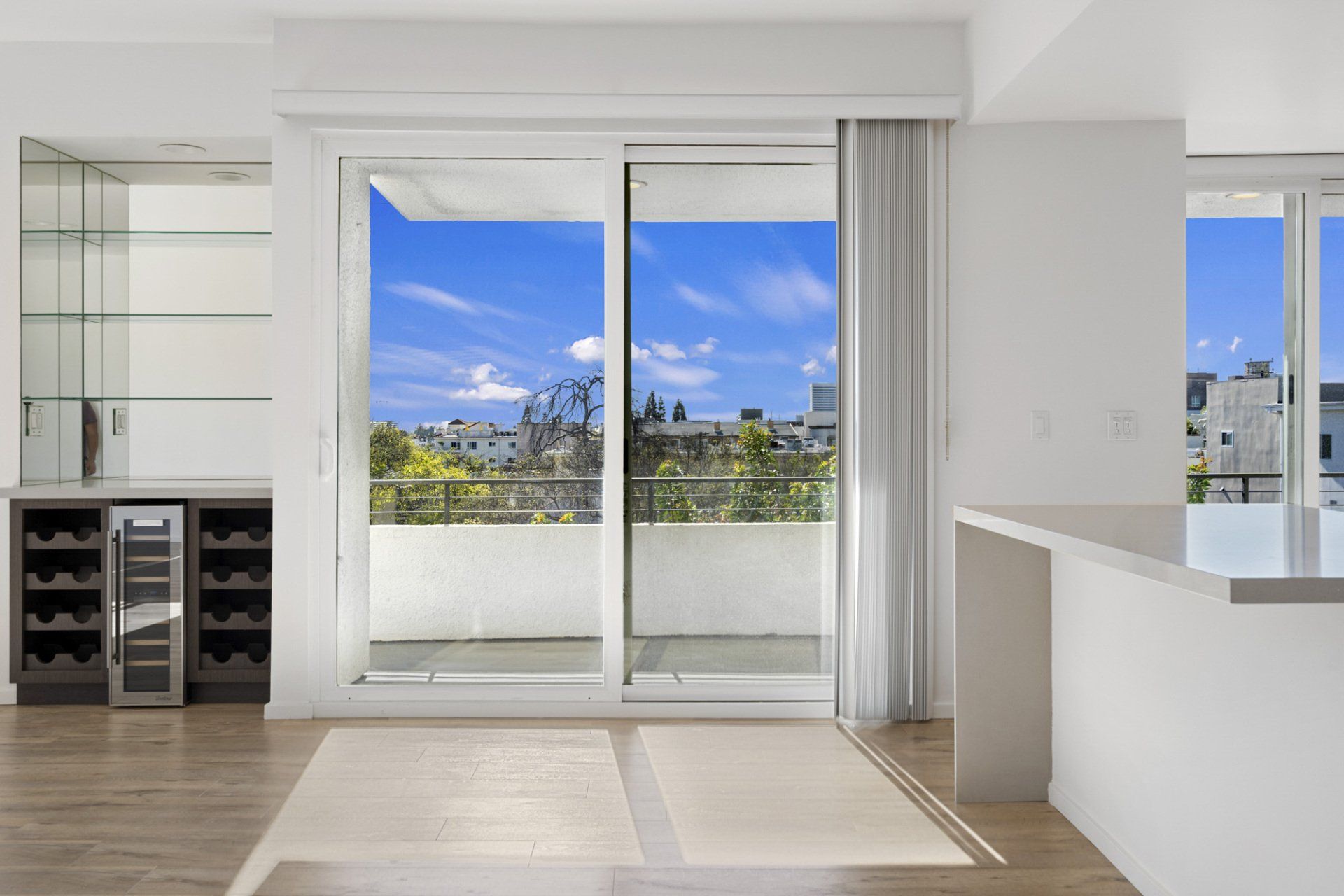 Interior view looking out large sliding door to exterior balcony